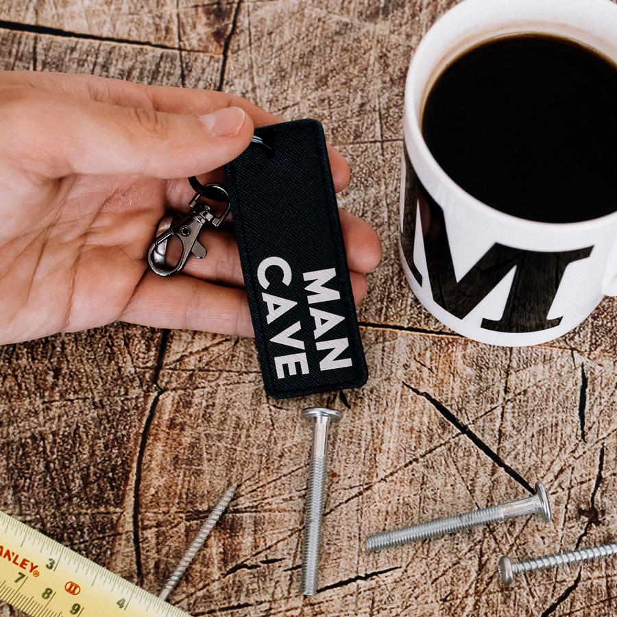 man cave keyring in black and gold