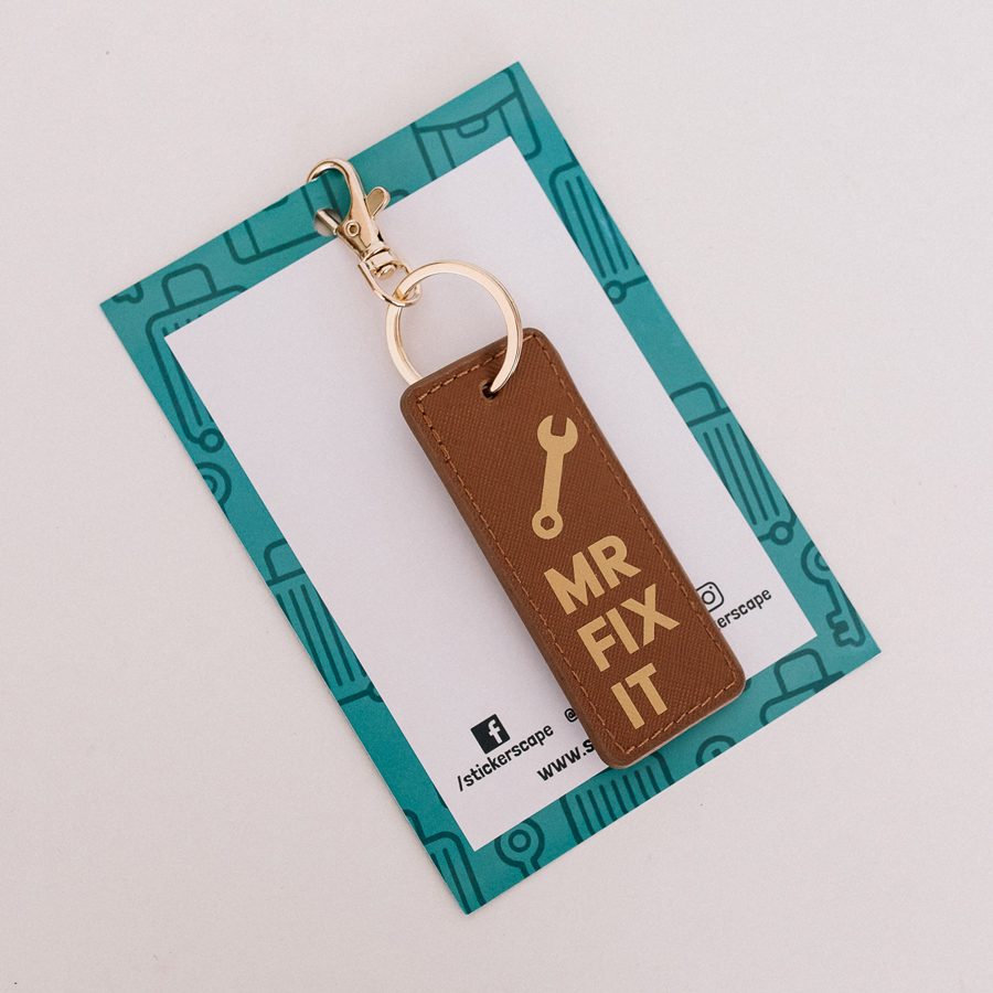 mr fix it keyring in black and gold