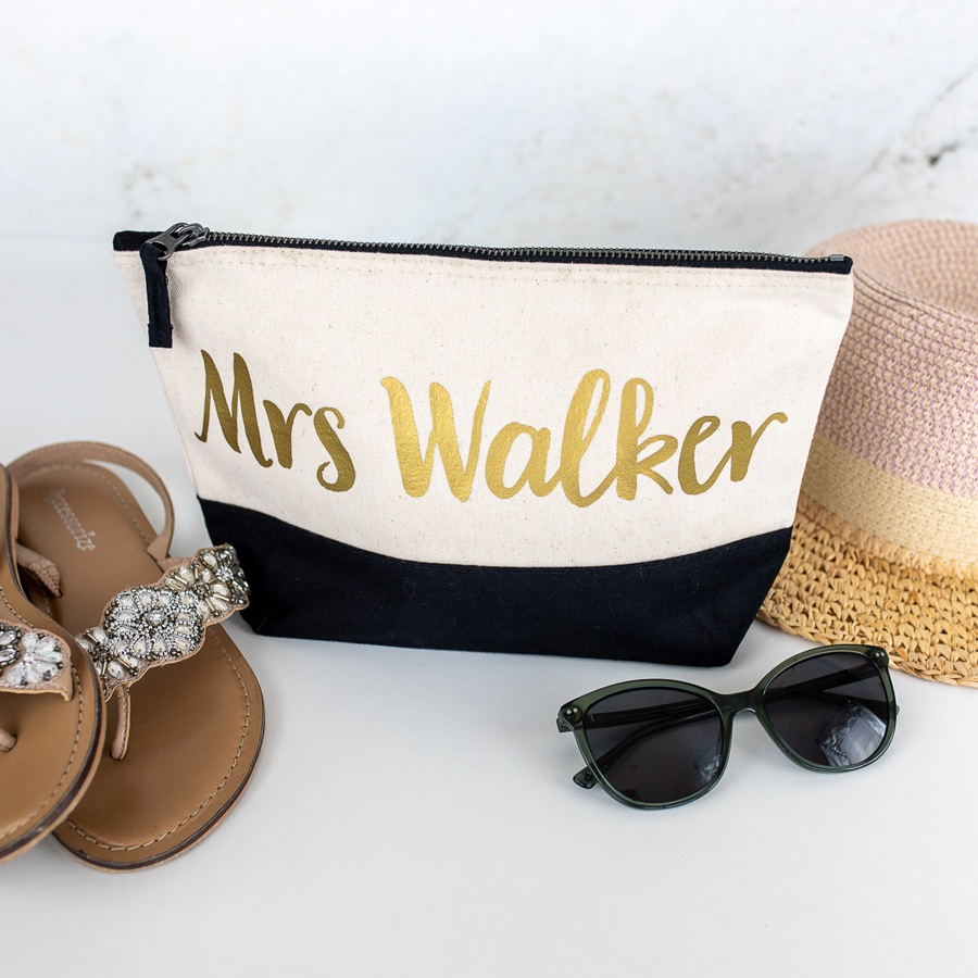 personalised last name wash bag in black with gold text