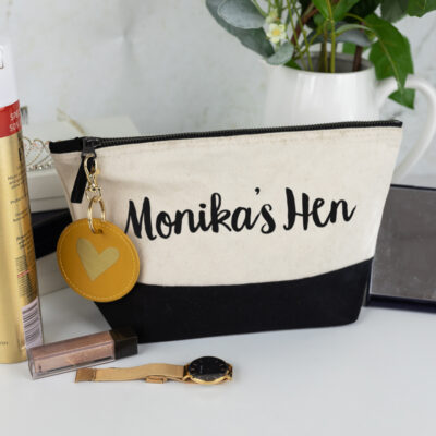 hen do bundle, black wash bag with black text, mustard keyring with a gold foil heart on the keyring