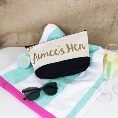 hen do bundle, black wash bag with gold text, blue keyring with gold foil glasses on the keyring