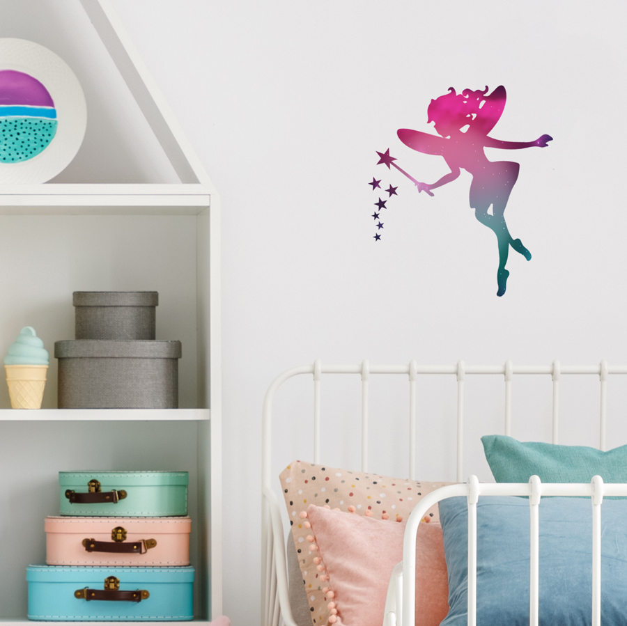 fairy silhouette sparkle wall sticker shown on a wall above a bed