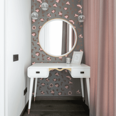 Colourful leopard print wall stickers in pink and brown shown on a grey wall behind a white vanity table and mirror