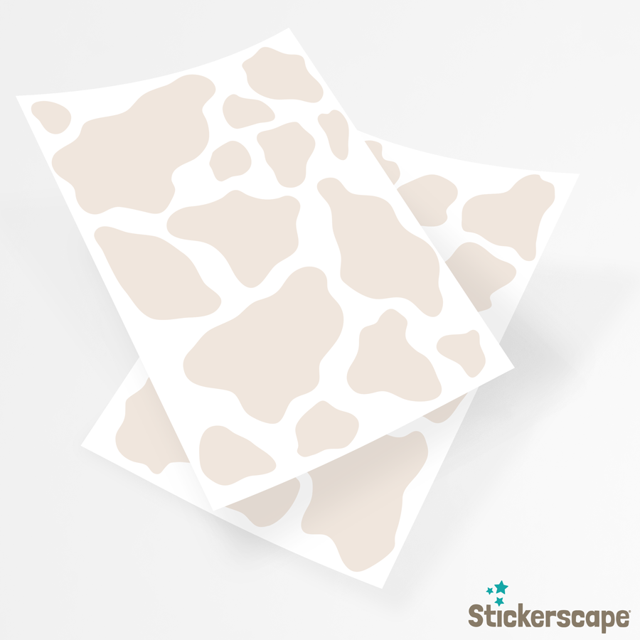 cow print wall sticker pack in light beige shown on the sheets