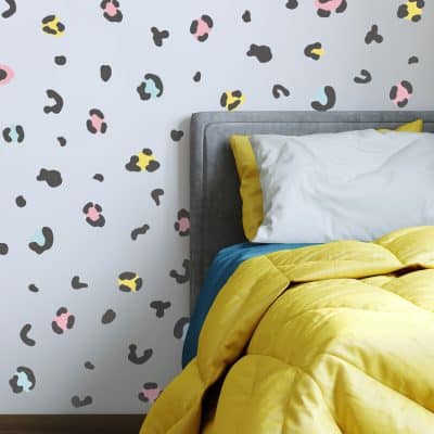 animal print wall stickers on a feature wall around a bed head