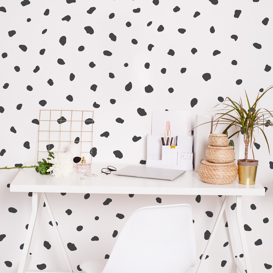 Dalmatian print wall sticker pack in black shown on a white wall behind a white desk