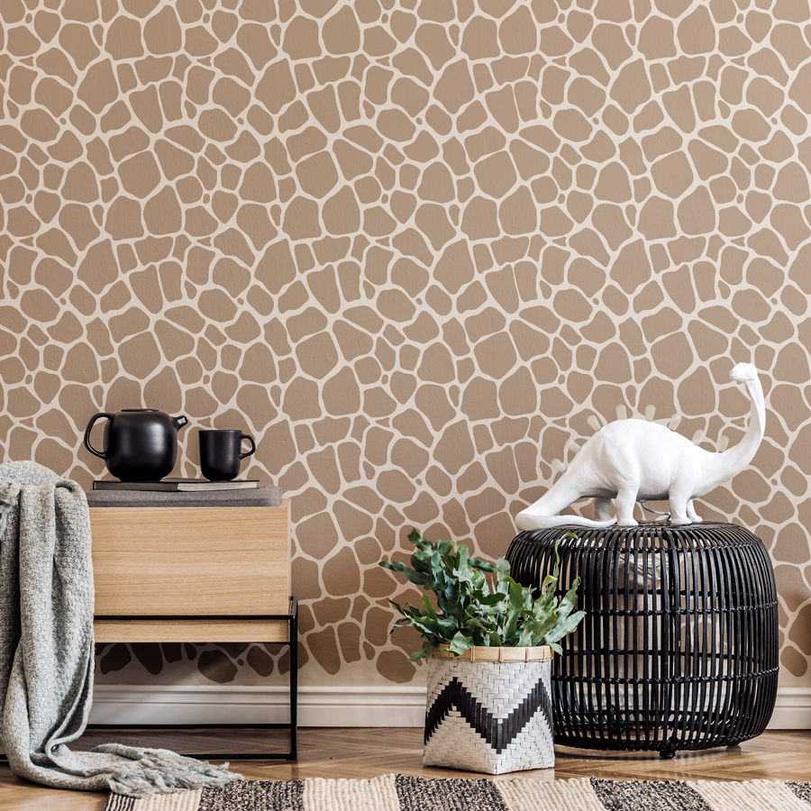 giraffe print wall sticker tile in brown shown on a light brown wall behind a wooden side table and black wire stool