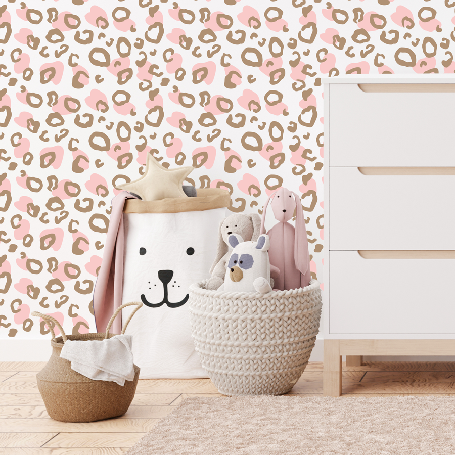 Two tone leopard print wall sticker tile in brown and pink shown on a white wall behind a white chest of drawers and two light coloured toy baskets