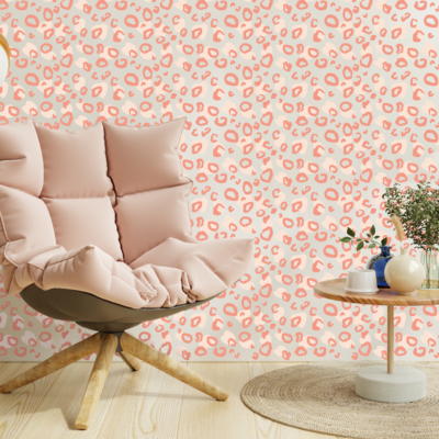 Two tone leopard print wall sticker tile in peach and pink shown on a light beige wakk behind a pink chair and a small light brown table