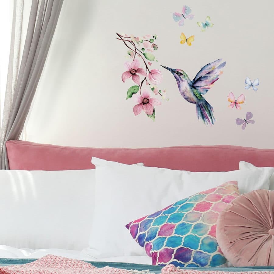 hummingbird and butterflies wall stickers shown on a white wall above a pink bed