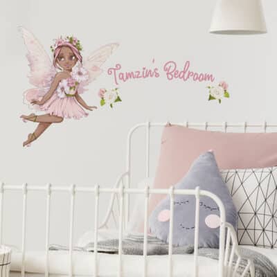 personalised flower fairy wall stickers in option 2 shown on a white wall above a headboard of a white bed