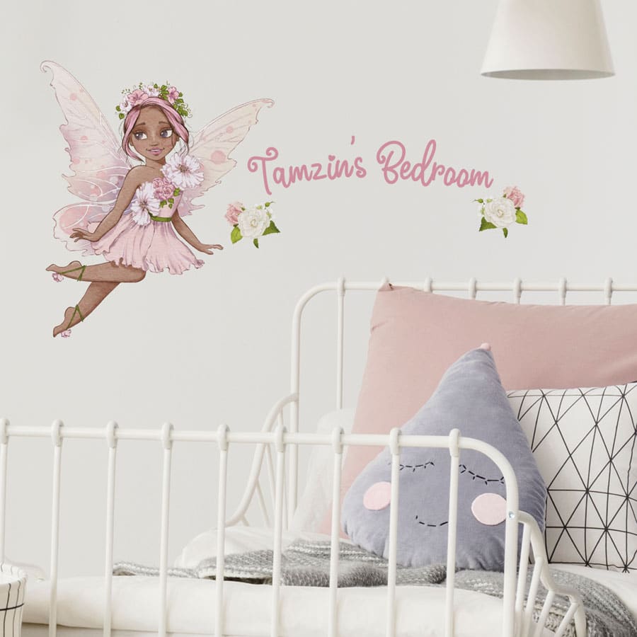 personalised flower fairy wall stickers in option 2 shown on a white wall above a headboard of a white bed