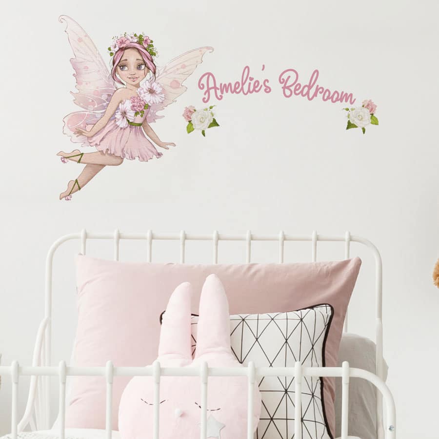 personalised flower fairy wall stickers in option 1 shown on a white wall above a headboard of a white bed