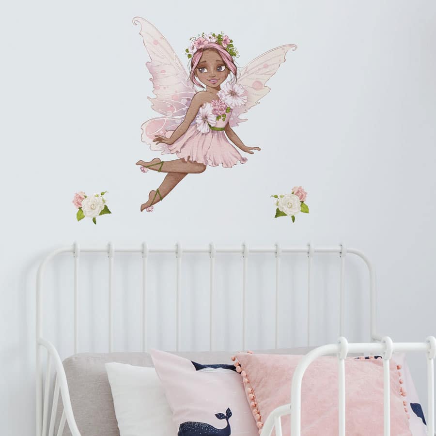 personalised flower fairy wall stickers in option 2 shown on a white wall above a headboard of a white bed