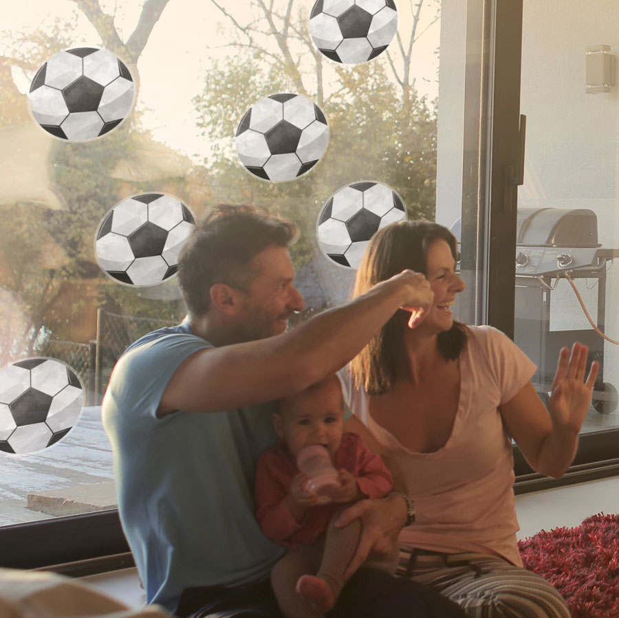 football window stickers shown on a window behind a young family