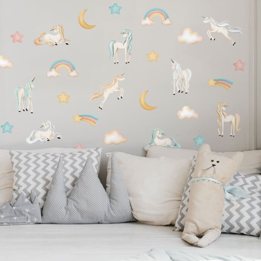 pastel watercolour unicorn wall sticker pack shown on a white wall behind a white sofa