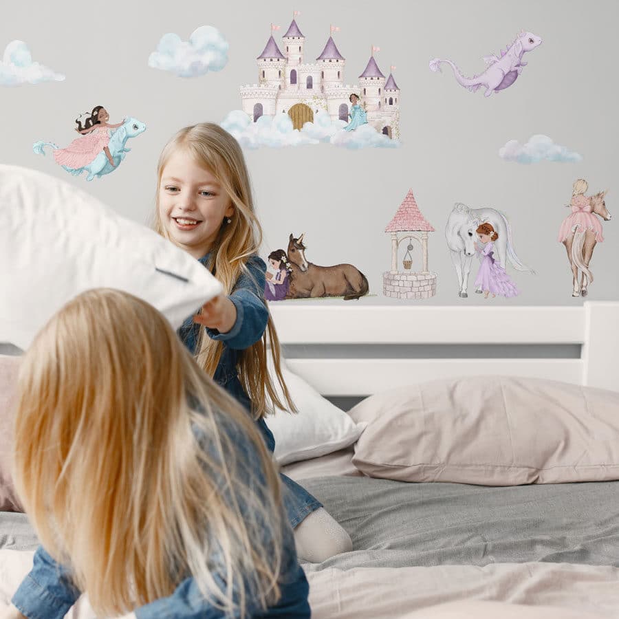storybook scene wall sticker pack shown on a light grey wall behind a pink and grey bed