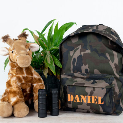 camo stencil backpack bag shown with a stuffed giraffe and binoculars