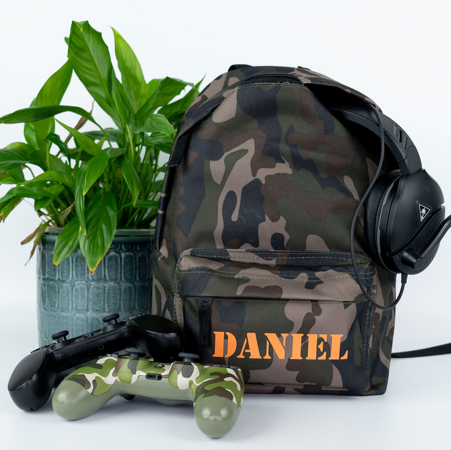 camo stencil backpack shown with game controllers