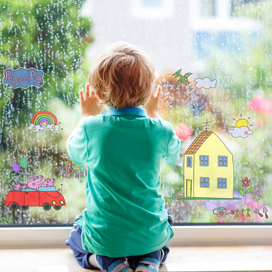 Peppa pig colour-in window stickers shown on a window in the rain in front of a child sat looking out