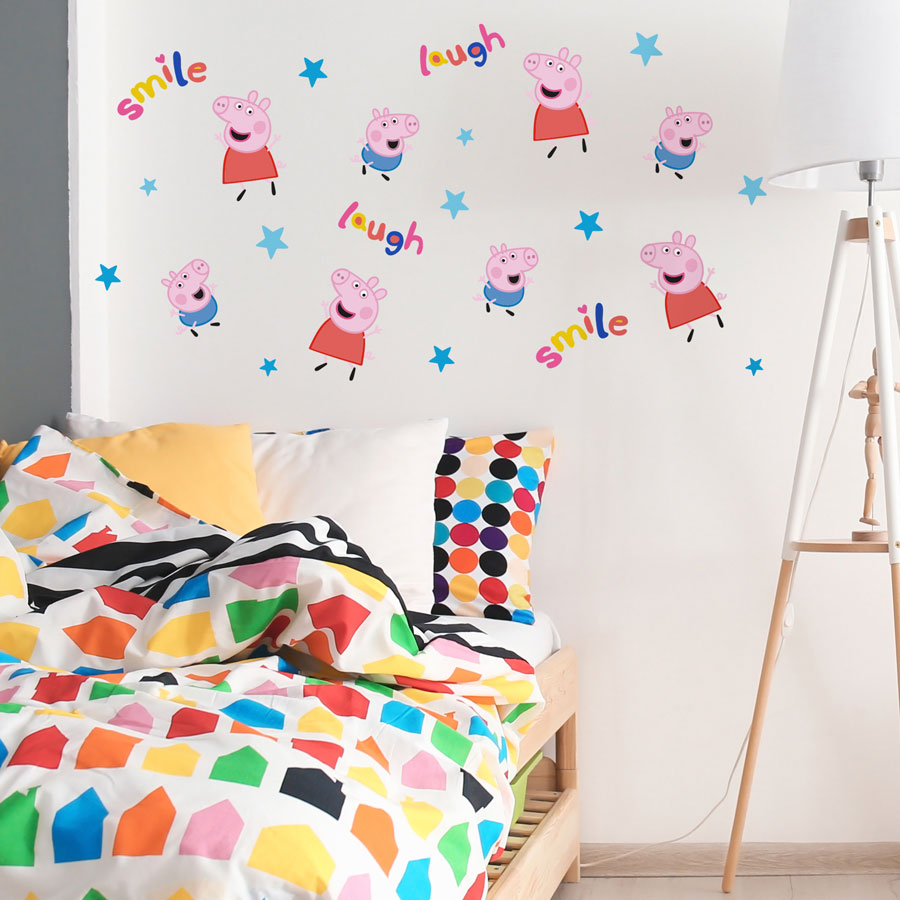 laugh & smile peppa pig wall sticker pack shown on a white wall behind a rainbow coloured bedspread