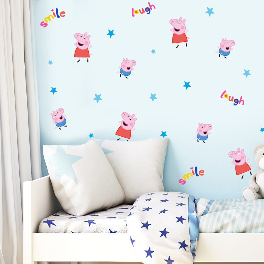 laugh & smile peppa pig wall sticker pack shown on a light blue wall behind a white bed