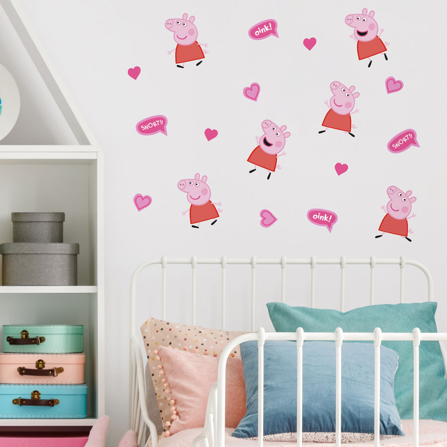 pink peppa pig wall stickers on a white wall behind a white bed