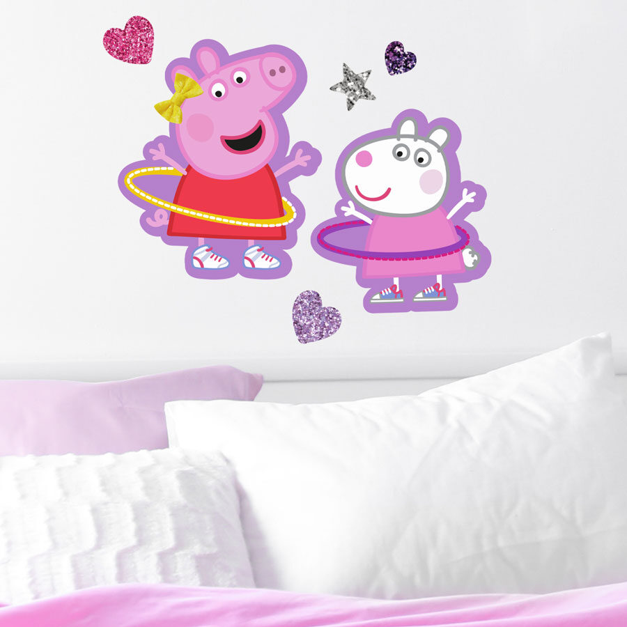 peppa & suzy wall sticker pack large shown on a white wall above white and pink pillowss