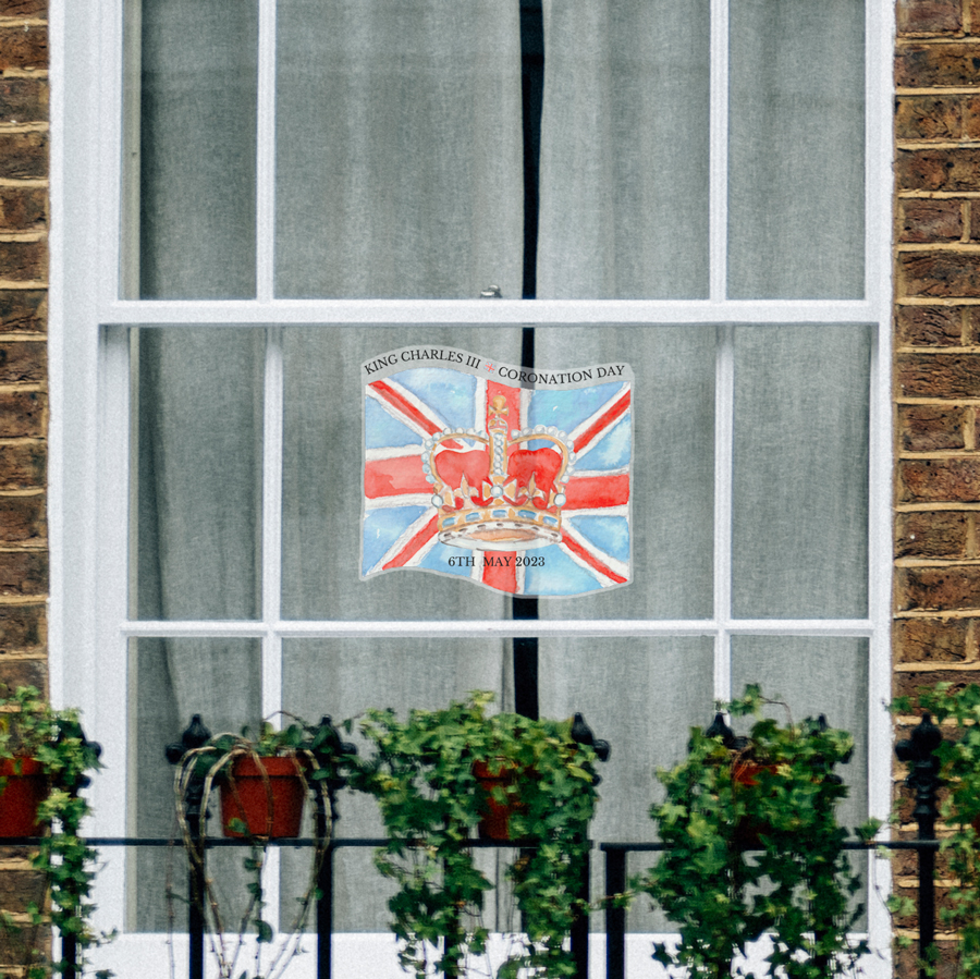 coronation flag window sticker shown facing out of a window in a home