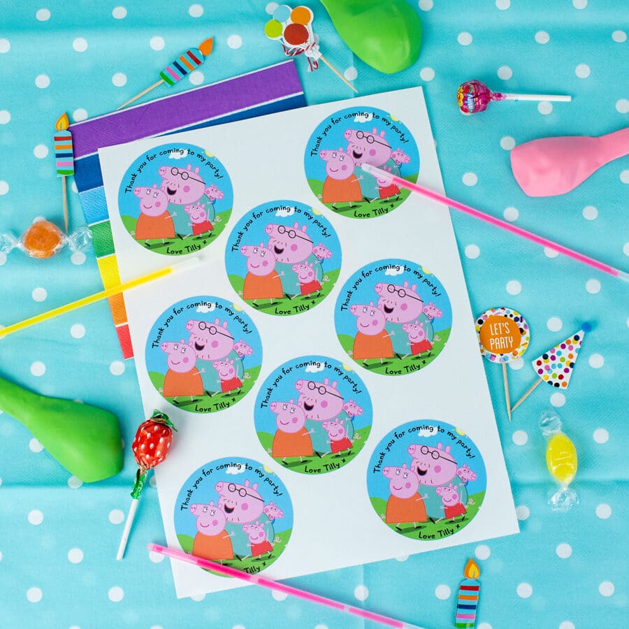 personalised peppa pig party label pack shown on sheet on top of a blue table cover