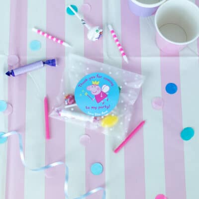personalised fairy peppa party label pack shown stuck on a clear party bag filled with sweets