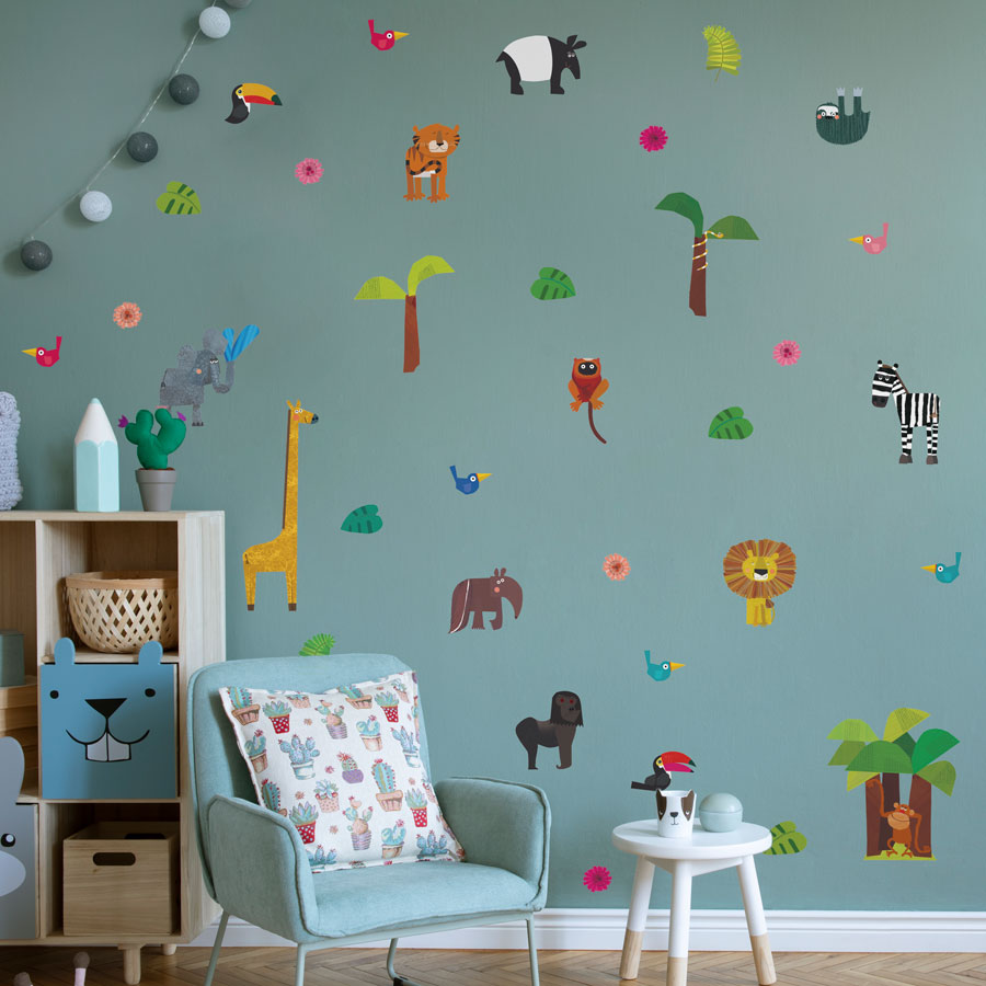 Jungle wall sticker pack designed by kali stileman shown on a light blue wall behind a light blue chair and light wood cabinet