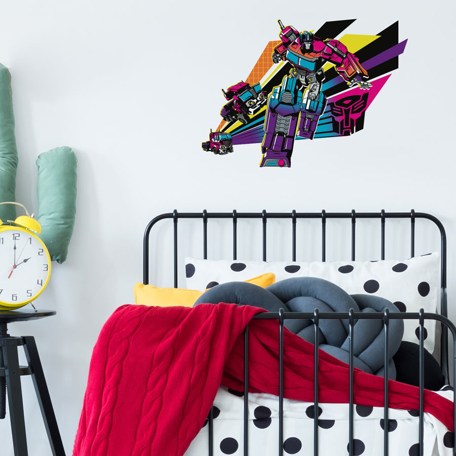 halftone optimus prime wall sticker shown on a white wall above a black headboard with red and white bedding