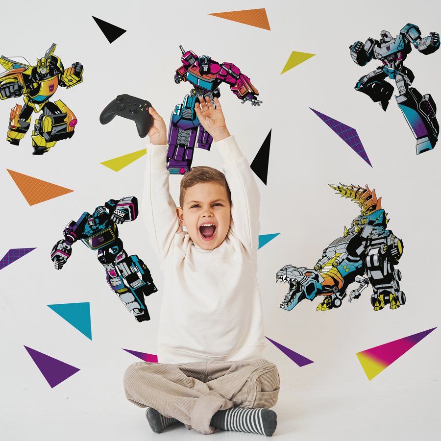 halftone transformers stickaround sholwn on a light coloured wall behind a child with a game controller