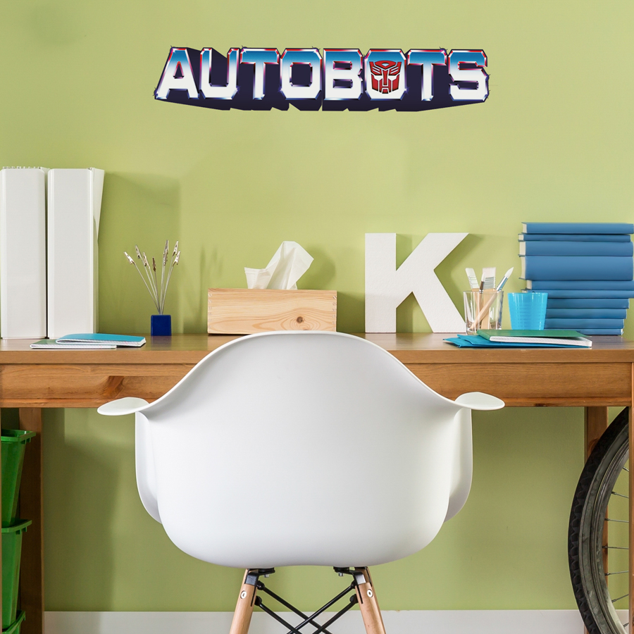 Autobots wall sticker regular shown on a green wall behind a wooden desk with white chair