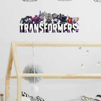 Decepticon group wall sticker on a light beige wall behind a wooden bed