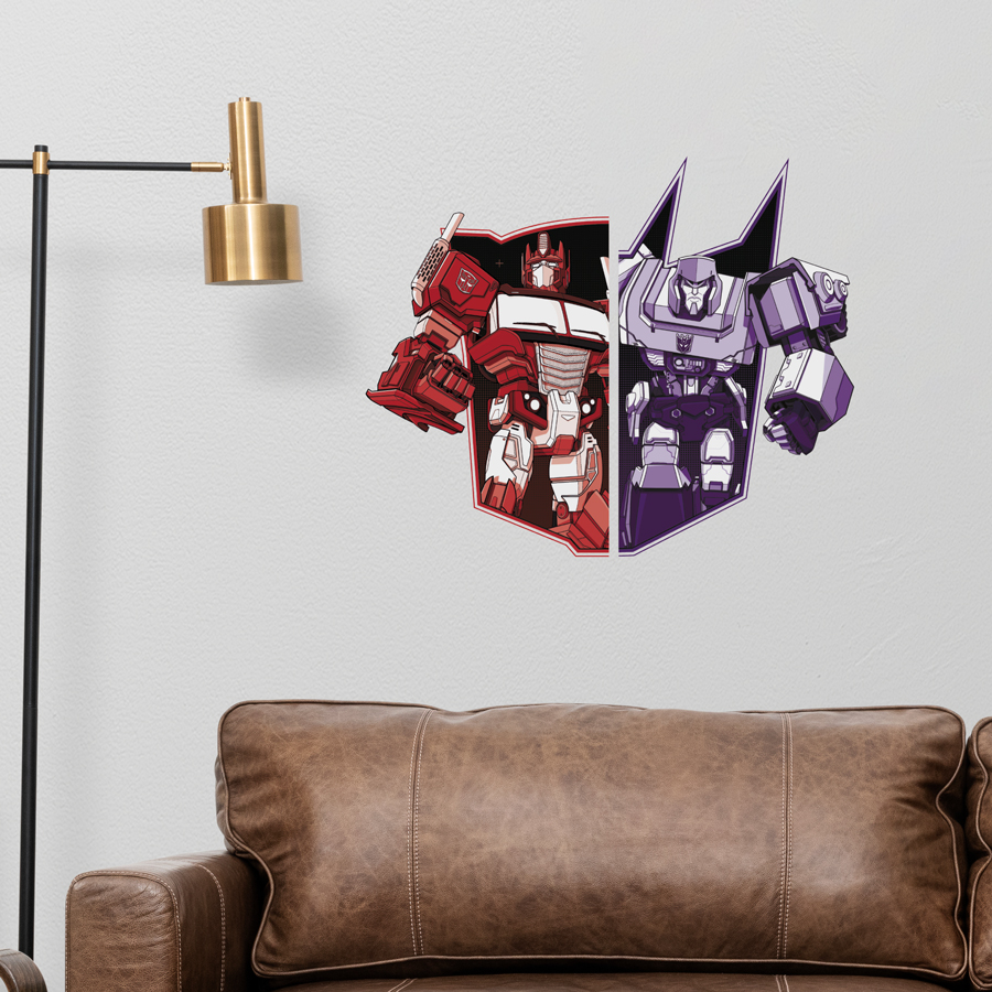 Optimus VS Megatron wall sticker shown on a light grey wall behind a brown leather sofa