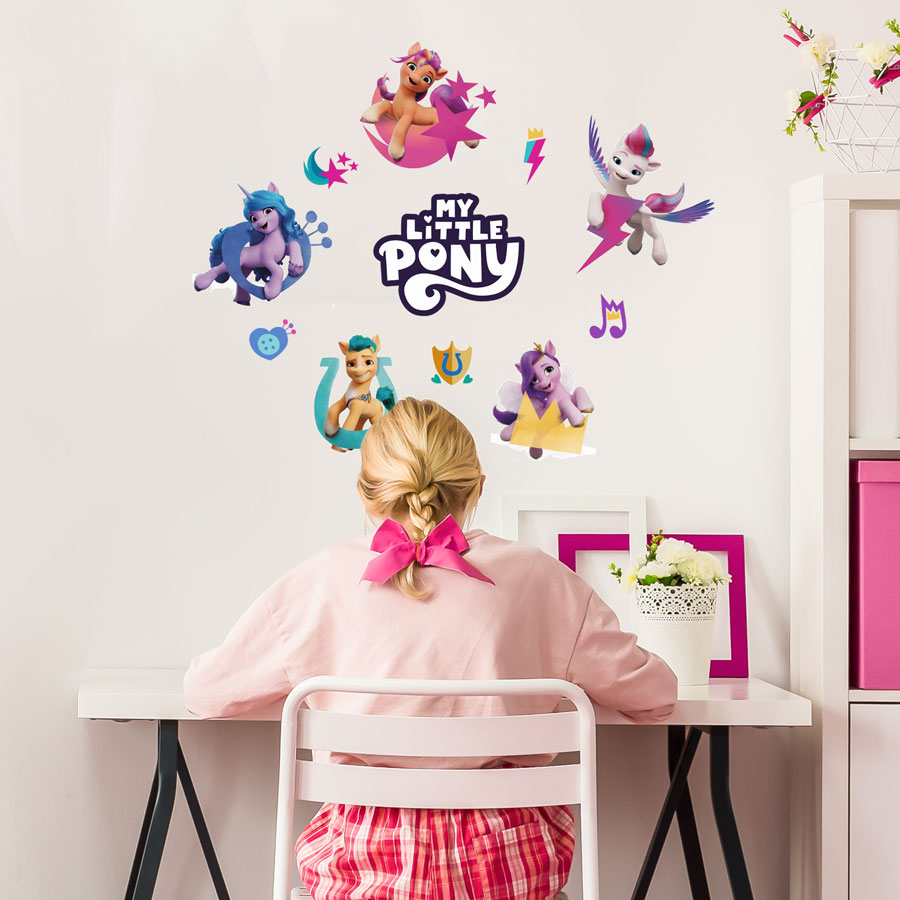Cutie Mark Wall Sticker Pack shown on a white wall above a child working at desk with pink accessories