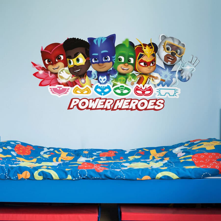 power heroes wall sticker shown on a light blue wall above a blue and red bed spread