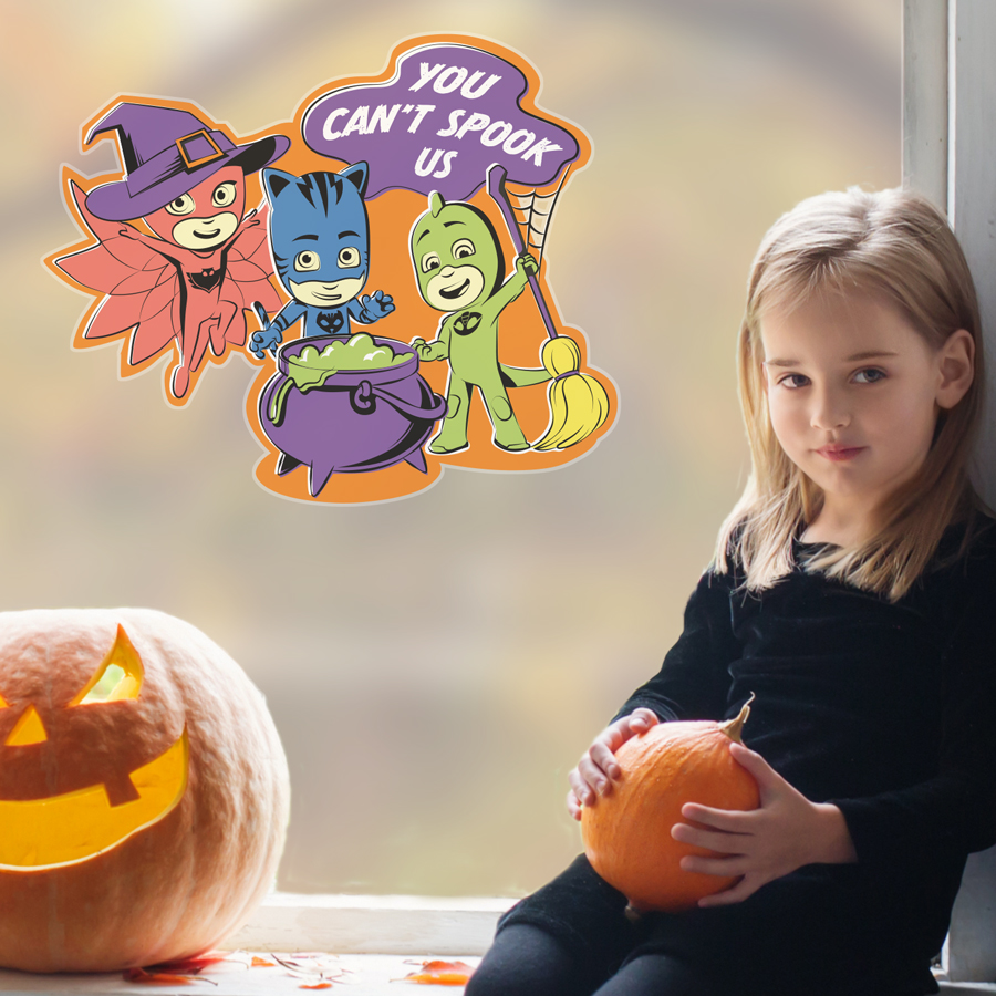 pj masks halloween window stickers large size shown on a window behind a girl holding a pumpkin
