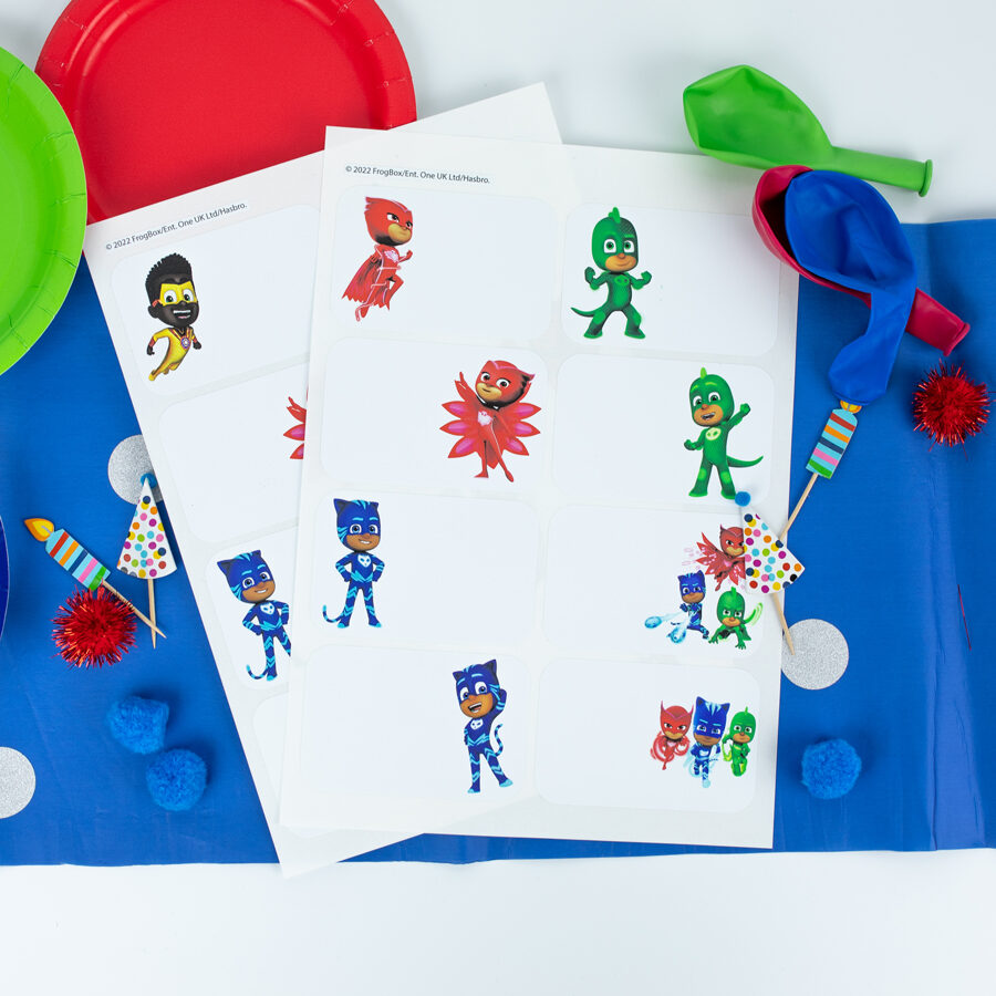 PJ Masks birthday label pack both sheets shown on a table decorated for a party