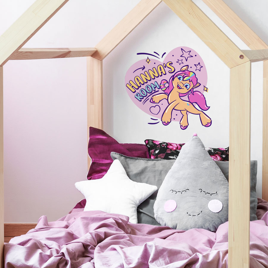 Personalised Sunny wall sticker option 2 regular shown on a white wall above a pink and grey bed