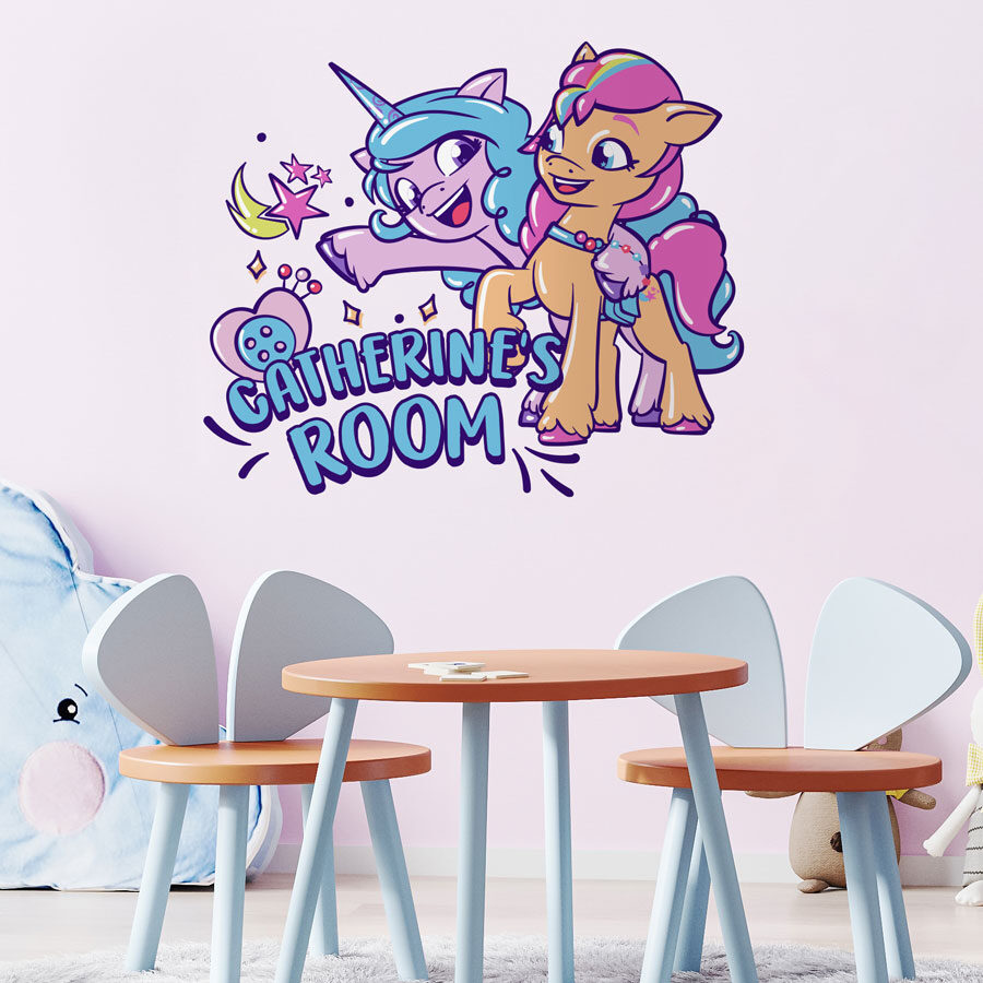 Personalised Sunny & Izzy wall sticker large shown on a light pink wall above a light blue and wood table