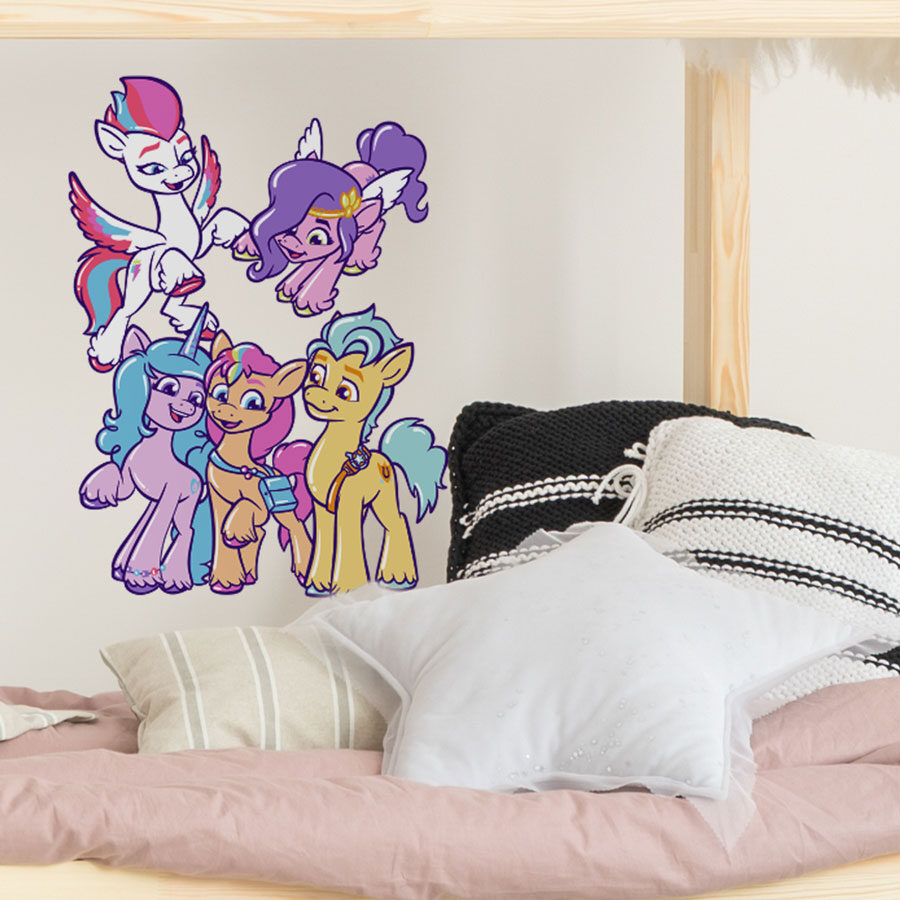 Cute My Little Pony group wall sticker large shown on a white wall behind a wooden bed with pink, white and black cushions