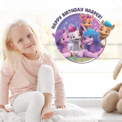 My Little Pony birthday window sticker shown on a window behind a child