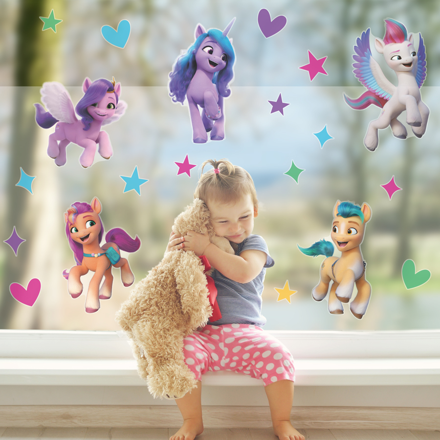 My Little Pony window sticker pack large shown behind a child with teddy bear