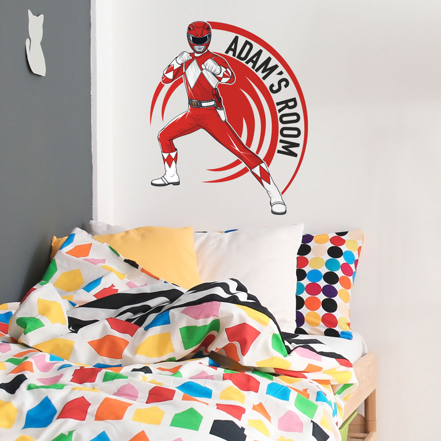 Personalised Rower Rangers wall sticker regular red shown on a white wall above a bed with a rainbow coloured bed spread