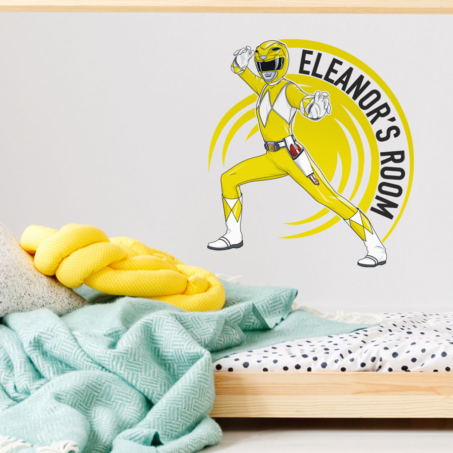 Personalised Rower Rangers wall sticker yellow regular shown on a white wall above a light wood bed with blue and yellow bedding