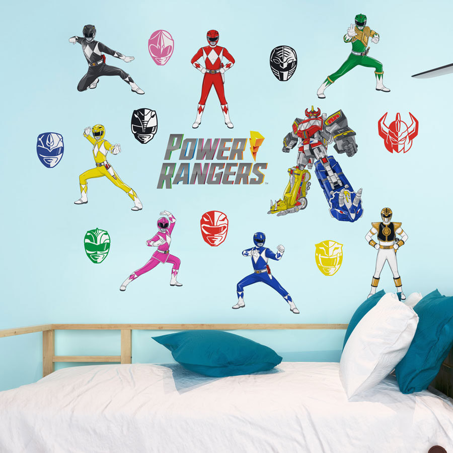 Power Rangers wall sticker pack shown on a light blue wall above a white and blue bed spread