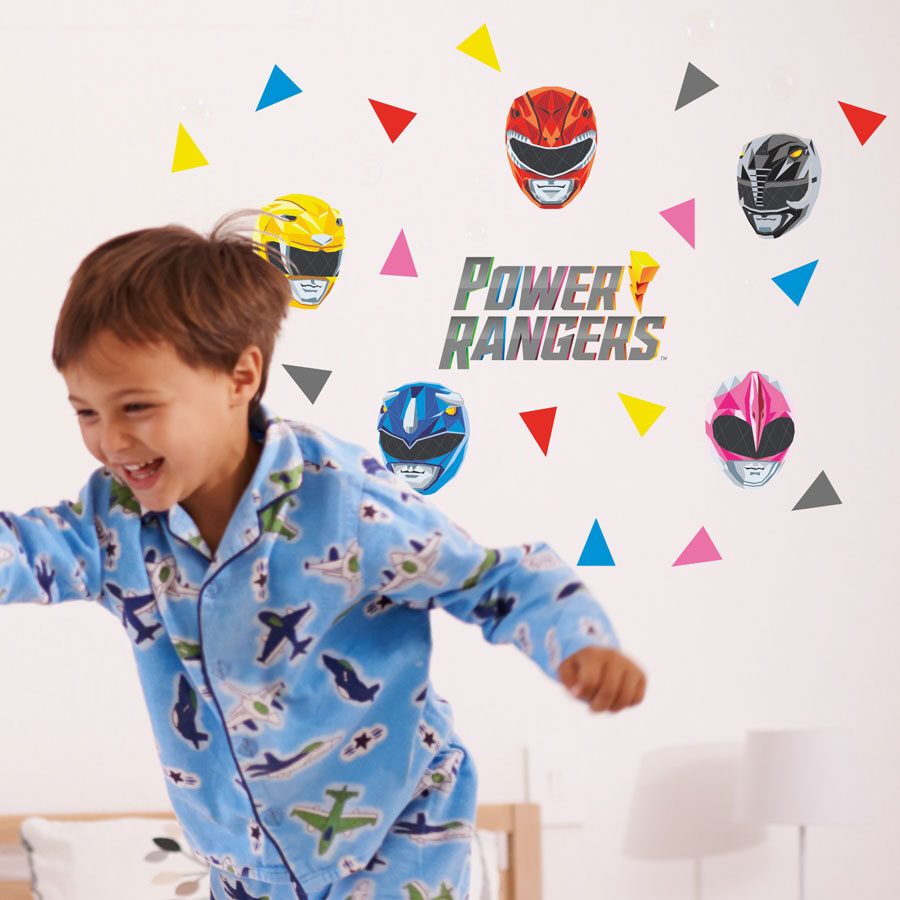 Power Rangers polygon wall sticker pack shown on a white wall behind a child in blue pyjamas running